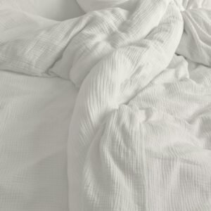 Soft pillows and quilt on bed
