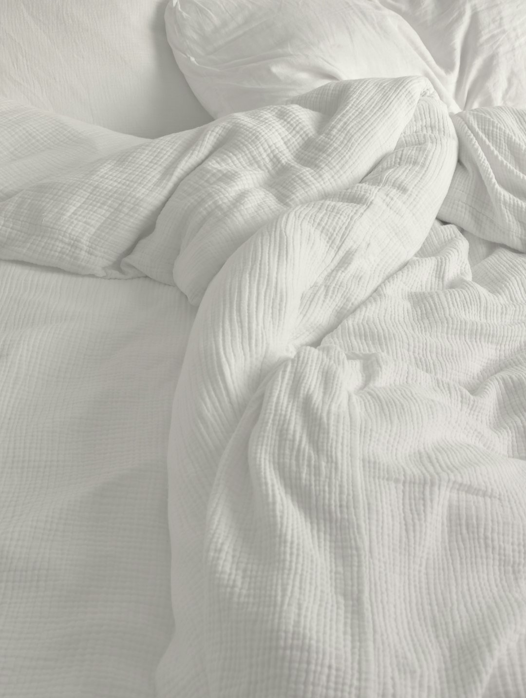 Soft pillows and quilt on bed