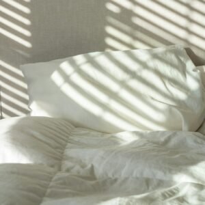 Bed with white cotton sheets and pillows