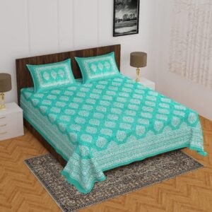 Turquoise double bedsheet with white buti print and matching pillow covers on a wooden bed