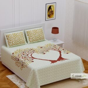 Cream double bedsheet with two trees forming a heart and golden leaves, with leaf print pillow covers