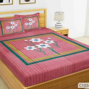Rose pink double bedsheet with white and blue flowers in a green frame and matching pillow covers