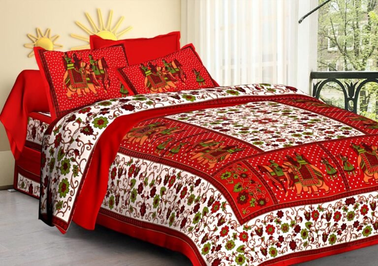 White floral double bedsheet with red Rajasthani elephant panels and matching elephant pillow covers