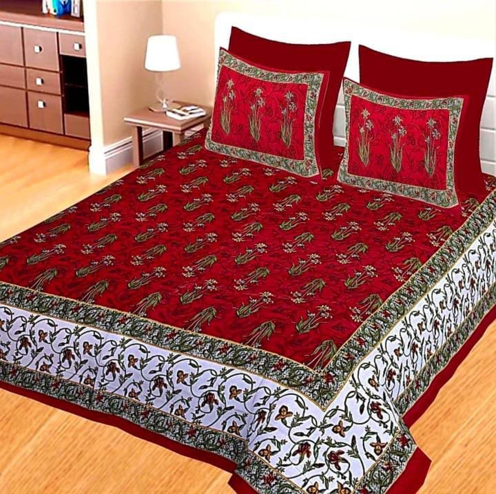 Maroon double bedsheet with green floral sprigs and white floral vine border with matching pillow covers