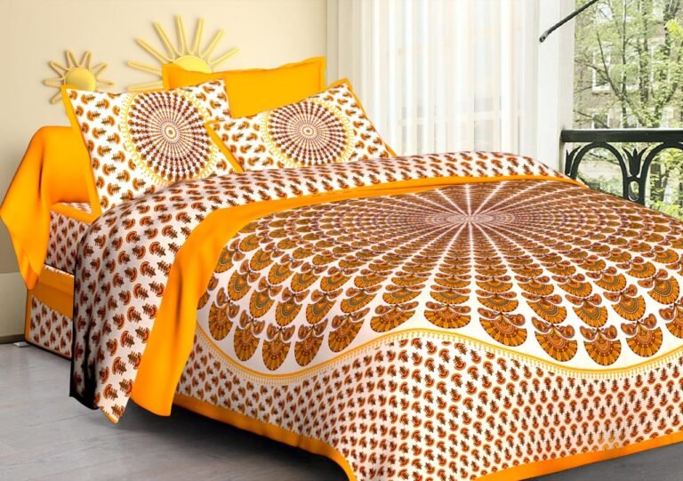 White double bedsheet with orange peacock feather sunburst, yellow band and mandala pillow covers