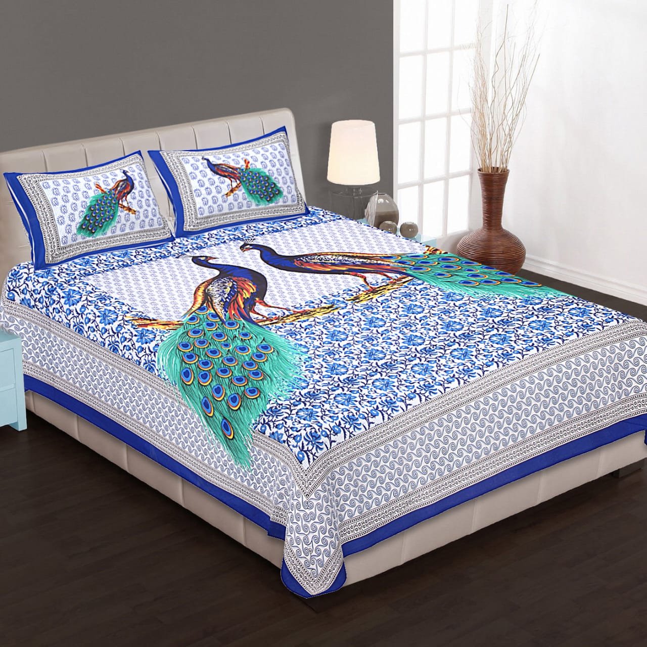 90 x 100 inch blue and white twin peacock print double bedsheet on a bed