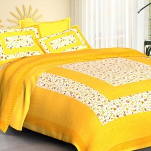Yellow double bedsheet with framed white floral panels and dotted yellow base with matching pillow covers