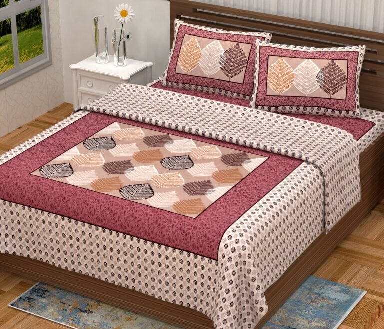 Cream double bedsheet with framed brown and peach leaf panel, maroon floral frame and leaf pillow covers