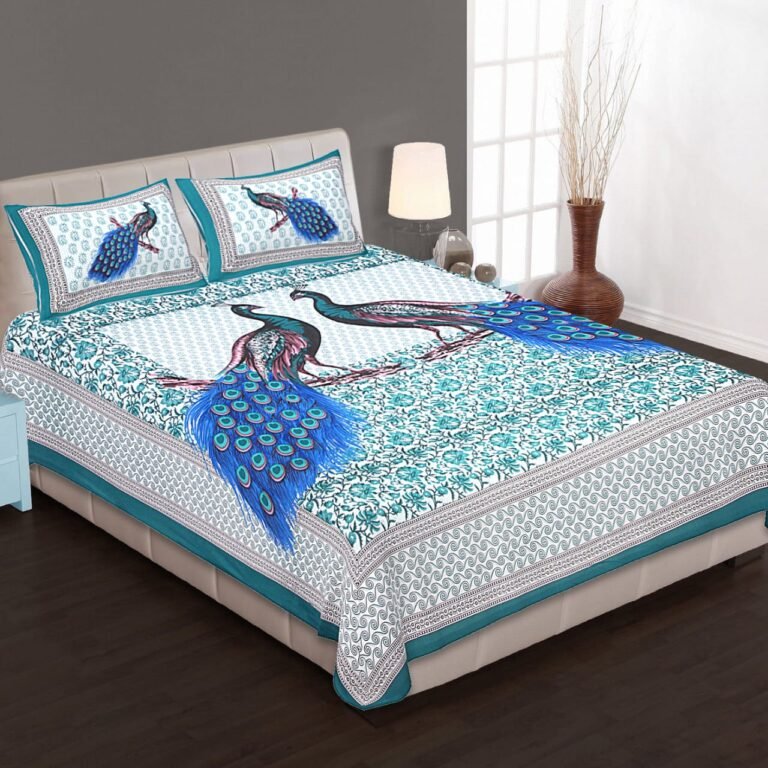 White and teal double bedsheet with two blue-tailed peacocks on a branch and peacock pillow covers